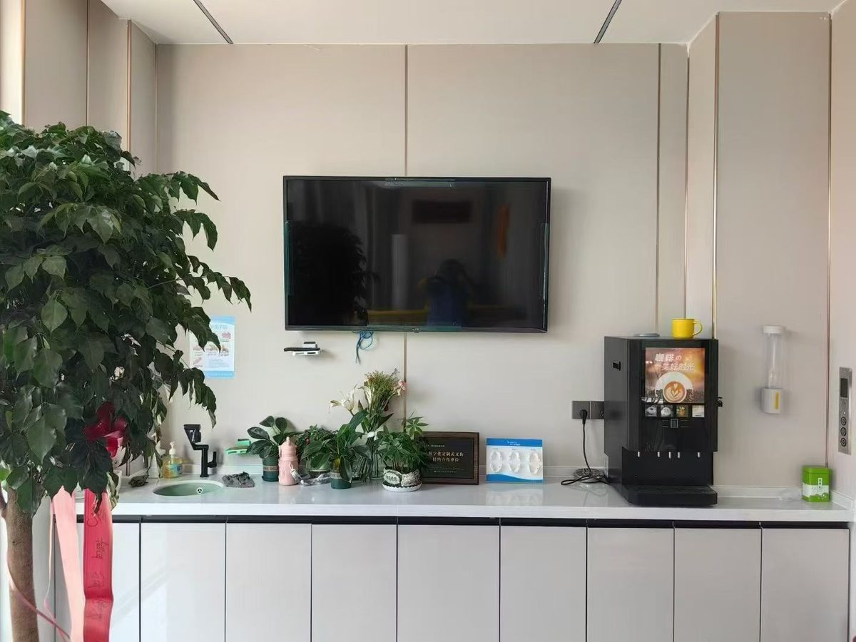 曹俊霞口腔候诊水吧实拍，配壁挂电视与自助咖啡机